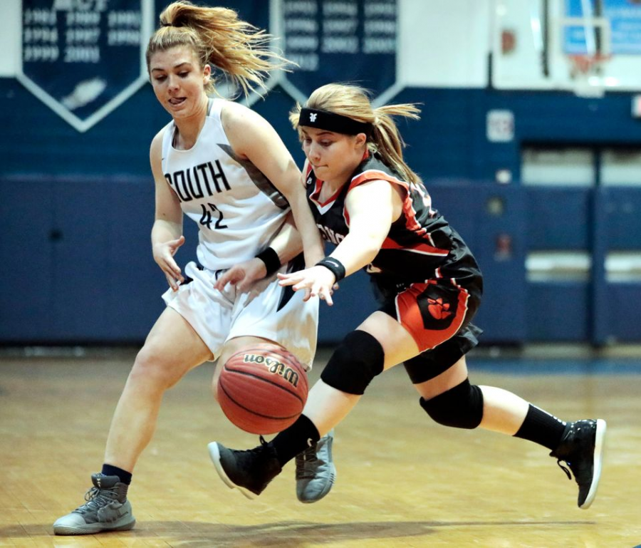Melissa Golembieski (junior) of Middletown North is fouled by South player helping defend.
